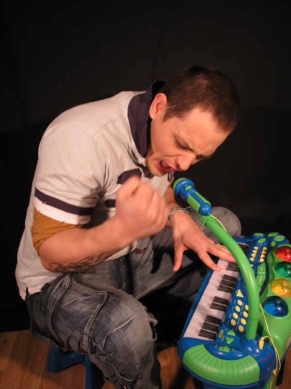 Oso Melodic singing into a toy microphone while playing a colorful keyboard